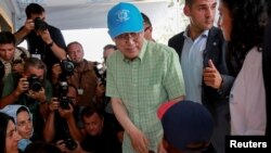 U.N. Secretary-General Ban Ki-moon greets a child during his visit at the municipality-run refugee camp of Kara Tepe on the island of Lesbos, Greece, June 18, 2016.