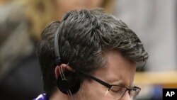 An MEP's wearing a scarf reacts after a vote on the UK's withdrawal from the EU, the final legislative step in the Brexit proceedings, during the plenary session at the European Parliament in Brussels, Jan. 29, 2020.