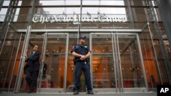 FILE - A police officer stands outside The New York Times building in New York, June 28, 2018.