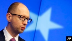 FILE - Ukraine's interim Prime Minister Arseniy Yatsenyuk speaks during a press conference in Brussels on March 6, 2014. 