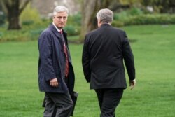 National Security Advisor Robert O'Brien walks with White House Chief of Staff Mark Meadows as U.S. President Donald Trump departs for a day trip in Washington, March 28, 2020.