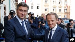 President of the European Council Donald Tusk, right, is welcomed by Croatia's prime minister Andrej Plenkovic in Zagreb, Croatia, Nov. 19, 2019. 