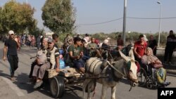 Палестинці тікають з міста Газа до південних районів, 8 листопада 2023. Photo by Mohammed ABED / AFP