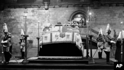 FILE - The remains of King George V lie in state until the royal funeral, with the Household troops standing guard at Westminster Hall in London on Jan. 23, 1936. (AP Photo, File)