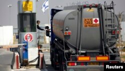 FILE - A tanker loaded with fuel for Gaza enters the Kerem Shalom crossing between Israel and the southern Gaza Strip, April 4, 2012. 
