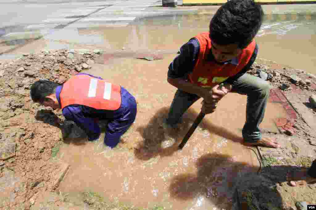 ក្រុម​ការងារ​រដ្ឋាករ​ទឹក​​ជួសជុល​ប្រព័ន្ធ​ទឹកស្អាត​បន្ទាប់​ពី​រថ​យន្ត​អេស្កា​វេទ័រ​ជីក​កកាយ​ដីប៉ះ​ប្រព័ន្ធទុយោ​បណ្ដាល​ឲ្យ​ធ្លាយ​ទឹក​បាចសាច​ចេញ​ក្រៅ​នៅ​ព្រឹក​ថ្ងៃអាទិត្យ ទី​១៤ ខែ​សីហា​ឆ្នាំ​២០១៦​។​​ក្រុម​ការងារ​នៃ​មន្ទីរ​សាធារណៈ​ការ​និង​ដឹកជញ្ជូន​ជួសជុល​បង្គោល​ភ្លើង​នៅ​ស្តុប​បូកគោ នៃ​ខ័ណ្ឌ​ចំការមន​ រាជធានី​ភ្នំពេញ​​។​(ឡេង ឡែន/VOA )
