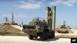 FILE - A photo made from the footage taken from the Russian Defense Ministry official website on Nov. 27, 2015, shows Russian S-400 air defense missiles being deployed at the Hemeimeem air base in Syria.