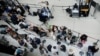 Passengers line up at a security checkpoint in Terminal 1 in John F. Kennedy International Airport one day after a global IT outage, in New York, on July 20, 2024.