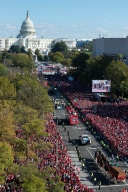 With the Capitol in the background, the Washington Nationals celebrate the team's World Series baseball championship over the Houston Astros, with their fans in Washington, Nov. 2, 2019.