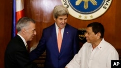 Philippine President Rodrigo Duterte, right, greets U.S. Ambassador to the Philippines Philip S. Goldberg, left, as Secretary of State John Kerry looks on during his visit at the Malacanang presidential palace in Manila, Philippines on Wednesday, July 27,