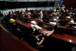Anti-extradition bill protesters are seen inside a chamber after they broke into the Legislative Council building during the anniversary of Hong Kong's handover to China in Hong Kong, July 1, 2019. (Reuters)