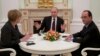 FILE - Russian President Vladimir Putin, center, gestures during his talks with German Chancellor Angela Merkel, left, and French President Francois Hollande, right, in Moscow, Feb. 6, 2015.