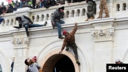 Supporters of U.S. President Donald Trump climb on walls at the U.S. Capitol during a protest against the certification of the 2020 U.S. presidential election results by the U.S. Congress, in Washington, U.S., January 6, 2021.