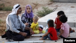 New Syrian refugees rest as they arrive at a stopover facility near the Turkish border town of Reyhanli in Hatay province, August 9, 2012. 