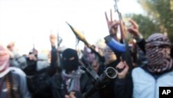 Gunmen gather in a street as they chant slogans against Iraq's Shi'ite-led government and demanding that the Iraqi army don't try to enter the city in Fallujah, Iraq, Jan. 7, 2014. 