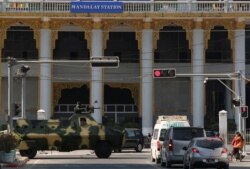 Myanmar military vehicles drive past a street after they seized power in a coup in Mandalay, Myanmar, Feb. 2, 2021.