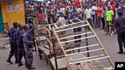 FILE - Liberia security forces blockade an area around the West Point Ebola center as the government clamps down on the movement of people to prevent the spread of the Ebola virus in Monrovia, Liberia. 