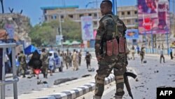 Un membre des services de sécurité somaliens patrouille sur les lieux d'un attentat suicide à la voiture piégée à Mogadiscio, le 30 août 2016.