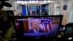President Trump is seen on a network monitor after his pre-recorded farewell speech was released, inside the Brady Press Briefing Room at the White House, January 19, 2021, in Washington. 