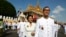 FILE PHOTO - Opposition leader of Cambodia National Rescue Party Sam Rainsy, foreground, walks together with his wife Tioulong Saumura after attending a celebration marking the 10th anniversary of Cambodian King Norodom Sihamoni's coronation, in front of the Royal Palace, in Phnom Penh, Cambodia, Wednesday, Oct. 29, 2014. In a rare public speech, Cambodia’s King Norodom Sihamoni urged his compatriots to be united for the sake of the nation. (AP Photo/Heng Sinith)