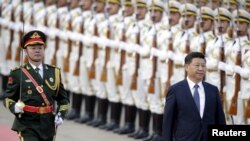 Presiden China XI Jinping memeriksa barisan kehormatan dalam upacara menyambut tamu negara, Presiden Nigeria Muhammadu Buhari (tidak nampak dalam gambar) di Beijing, China (Foto: dok).