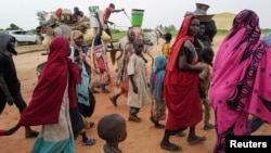 Warga Sudan, yang melarikan diri dari konflik di wilayah Darfur, Sudan, berjalan melintasi perbatasan antara Sudan dan Chad di kota Adre, Chad. 