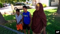 Fathi Mahamoud, 11, left, Esrom Habte, 12, center, and Thado Aip describe the Saturday night attack that left nine fellow residents of their Boise, Idaho, apartment complex with stabbing injuries, July 1, 2018.