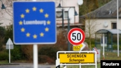 FILED - A street sign marks the beginning of Schengen, Luxembourg January 27, 2016. The Schengen Agreement with the goal to eliminate internal border controls was signed on June 14, 1985 in the village at the river Moselle and the tripoint of France, Germany and the Netherlands.