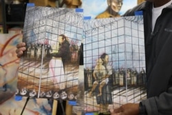 Ricardo Santos Hernandez's mixed media piece "Caged" serves as a study for a mural he is planning on painting in Chicago this year. The project will have many political themes including immigration. (Kulsoom Khan/VOA)