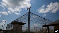 FILE - In this 2015 photo, a fence stands at Elmore Correctional Facility in Elmore, Ala.