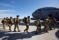 U.S. Army paratroopers of an immediate reaction force from the 2nd Battalion, 504th Parachute Infantry Regiment, 1st Brigade Combat Team, 82nd Airborne Division, board their C-17 aircraft at Fort Bragg, N.C., Jan. 1, 2020.