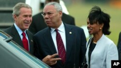FILE - Former President George W. Bush arrives at Shannon Airport in western Ireland with Colin Powell, who was then his secretary of state, and Condoleeza Rice, who was his national security adviser, June 25, 2004.