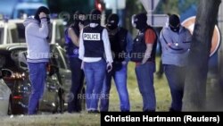 French policemen take part in a police raid at a residential building in Boussy-Saint-Antoine near Paris, France, Sept. 8, 2016. Police were investigating an abandoned car packed with gas cylinders near Paris' Notre Dame cathedral. 