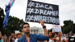 Carlos Esteban, 31, of Woodbridge, Va., a nursing student and recipient of Deferred Action for Childhood Arrivals, known as DACA, rallies with others in support of DACA outside of the White House, in Washington, Sept. 5, 2017. 