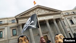 People protest a bill to legalize euthanasia as the Spanish parliament prepares to vote on it, outside the Spanish parliament in Madrid, Dec. 17, 2020.