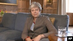 In this image taken from video released by Downing Street, April 7, 2019, showing Britain's Prime Minister Theresa May defending her position on Brexit, and her decision to hold cross-party talks with opposition Labour Party, in a video message filmed at 