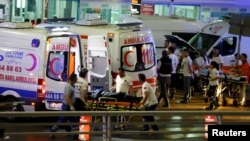 FILE - Paramedics push a stretcher at Turkey's largest airport, Istanbul Ataturk, following a blast in Turkey, June 28, 2016. 