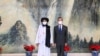 Chinese State Councilor and Foreign Minister Wang Yi, right, meeting with Mullah Abdul Ghani Baradar, political chief of Afghanistan's Taliban, in Tianjin, in this photo taken on July 28, 2021, and released by China's Xinhua News Agency.