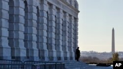 A lone Capitol Police officer guards his post, Jan. 19, 2018, on Capitol Hill in Washington.