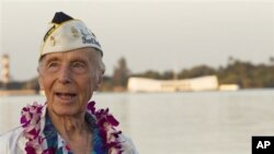 With the USS Arizona memorial in the background, Pearl Harbor survivor Richard Laubert, of Phoenix, Oregon, attends the 69th anniversary ceremony marking the attack on Pearl Harbor, 7 Dec 2010, in Pearl Harbor, Hawaii