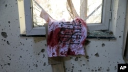 A bloodstained Taliban flag is seen on the window inside the Kabul University after a deadly attack in Kabul, Afghanistan, Nov. 3, 2020. 