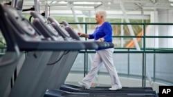 FILE - A woman, who suffers from diabetes, is seen walking on a treadmill as part of an exercise program to help control the disease.