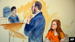 This courtroom sketch depicts Maria Butina, a 29-year-old gun-rights activist suspected of being a covert Russian agent, listening to Assistant U.S. Attorney Erik Kenerson as he speaks to Judge Deborah Robinson during a hearing in federal court in Washington, July 18, 2018.