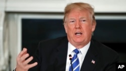 President Donald Trump speaks in the State Dining Room of the White House in Washington, Feb. 12, 2018.