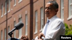 U.S. President Barack Obama rolls up shirt sleeve before speaking about his vision to reduce carbon pollution, Georgetown University, Washington, June 25, 2013.