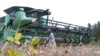 FILE - A farmer checks his combine as he gets ready to harvest his soybean crop at his farm in Turbeville, South Carolina, Oct. 5, 2016.