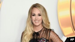 FILE - Carrie Underwood attends the 2018 Radio Disney Music Awards in Los Angeles, June 22, 2018.