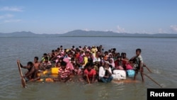 FILE - Rohingya refugees cross the Naf River to reach Bangladesh at Sabrang near Teknaf, Bangladesh, Nov. 10, 2017.