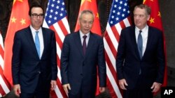 Chinese Vice Premier Liu He, center, poses with U.S. Trade Representative Robert Lighthizer, right, and Treasury Secretary Steven Mnuchin, for photos before holding talks at the Xijiao Conference Center in Shanghai Wednesday, July 31, 2019. (AP…