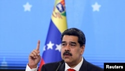 FILE - Venezuelan President Nicolas Maduro speaks during a news conference in Caracas, Dec. 8, 2020.